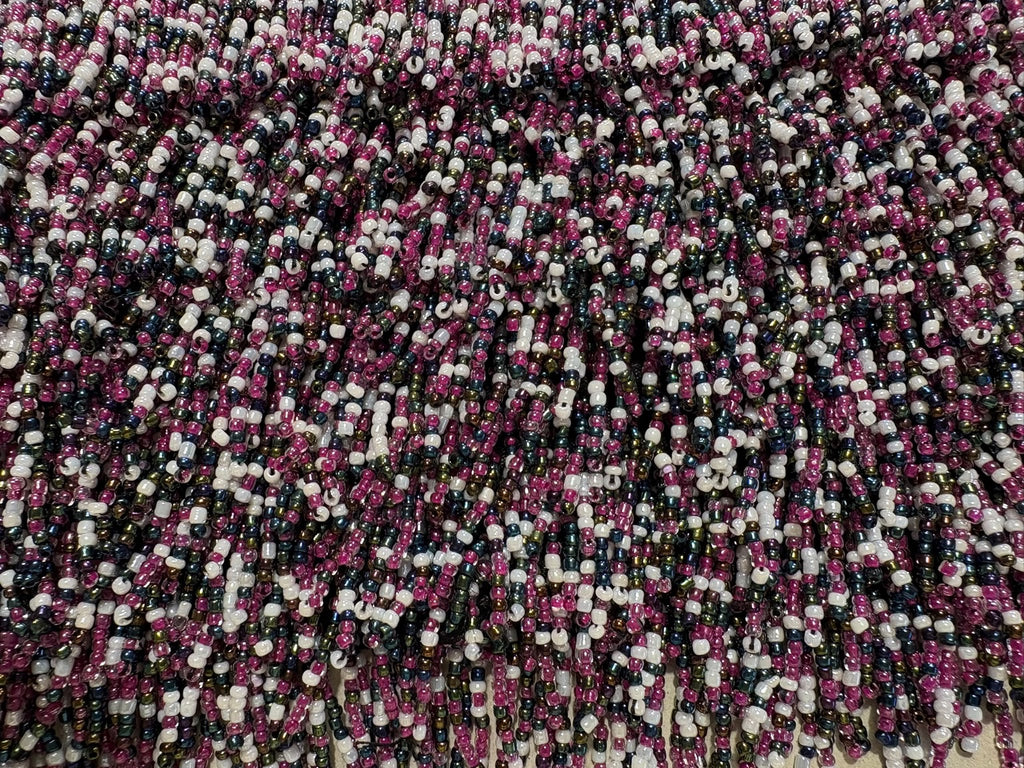 Close-up of purple, white and black beads on decorative ribbon trim