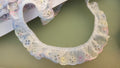 White and pastel gathered Broderie Anglaise lace