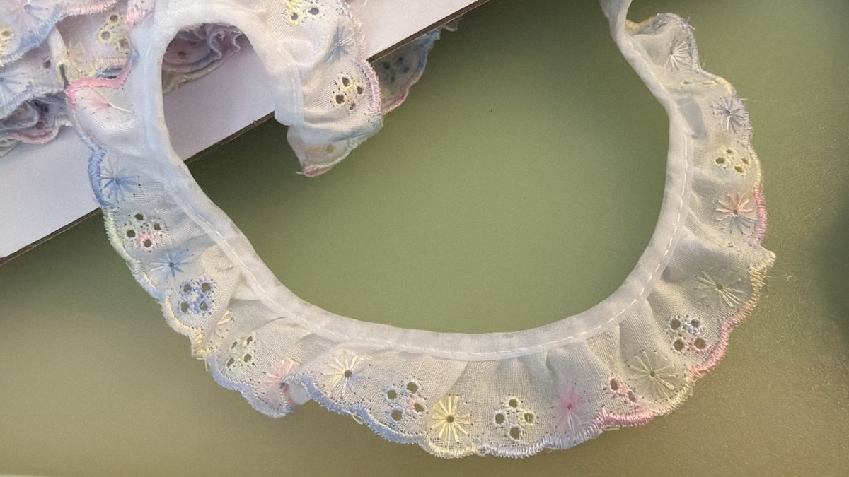 White and pastel gathered Broderie Anglaise lace