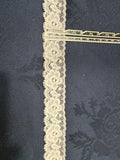 Ivory stretch lace trim 30mm wide with circular floral pattern and picot edges, shown on denim fabric with a ruler for scale