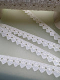 Cream broderie anglaise trim with eyelet cutwork and decorative geometric edge, 15mm wide