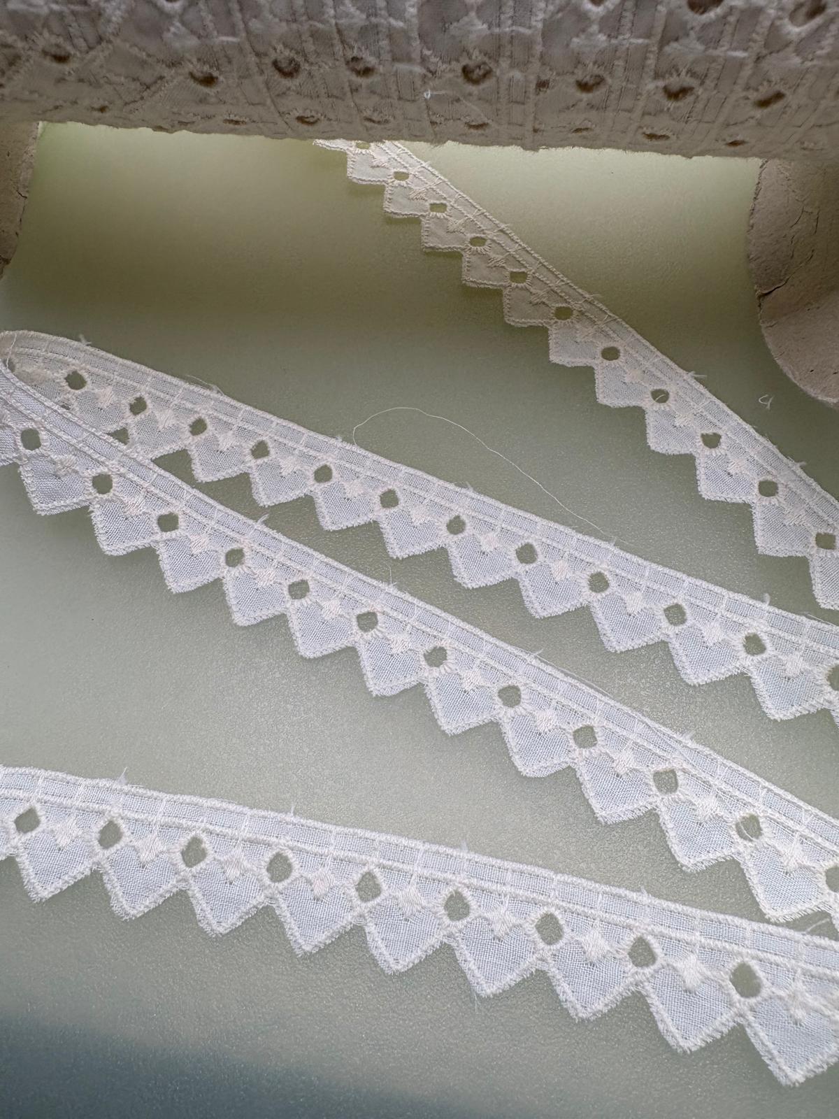 Cream broderie anglaise trim with eyelet cutwork and decorative geometric edge, 15mm wide