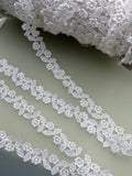 Ivory guipure lace trim with delicate repeating flowers and leaves, 15mm wide