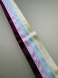Multicoloured striped ribbon in yellow, turquoise, pink and plum