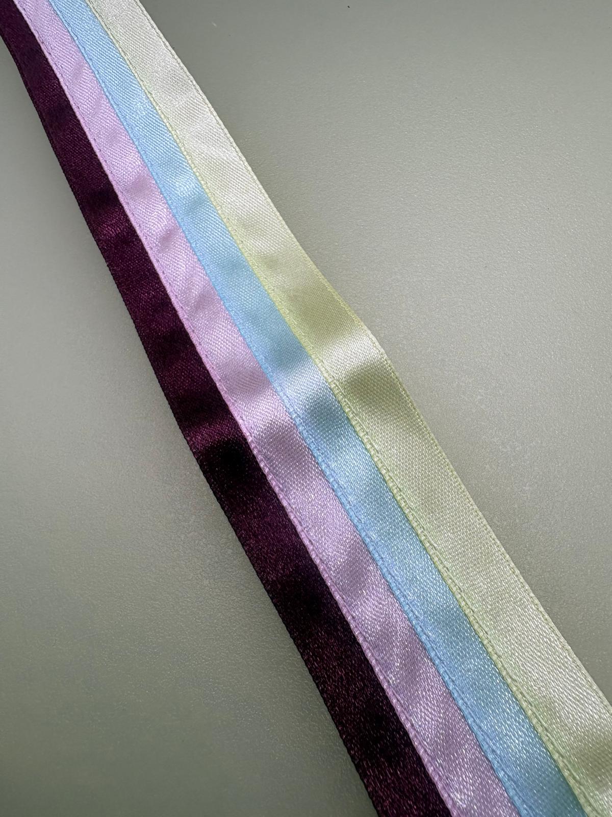 Multicoloured striped ribbon in yellow, turquoise, pink and plum