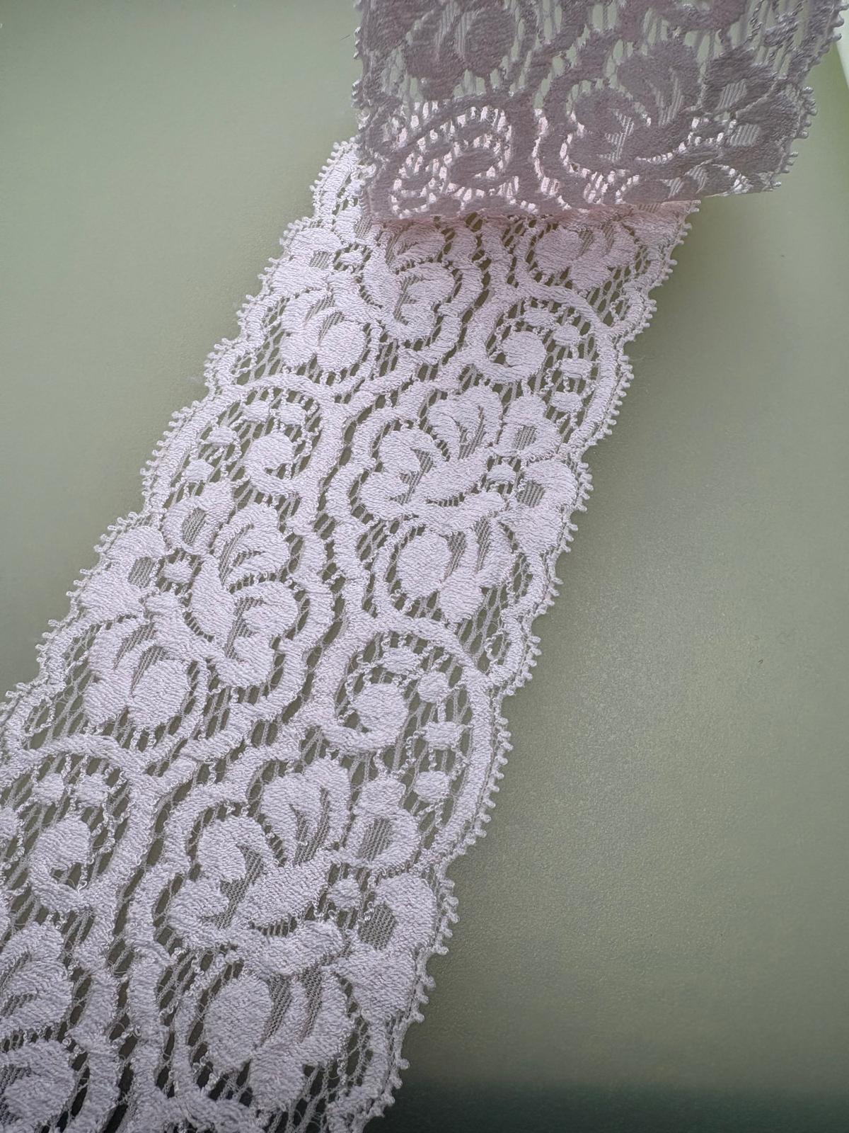 Pink couture-style stretch lace with textured openwork pattern
