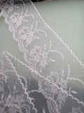 Sheer white embroidered organza with floral and trailing vine design