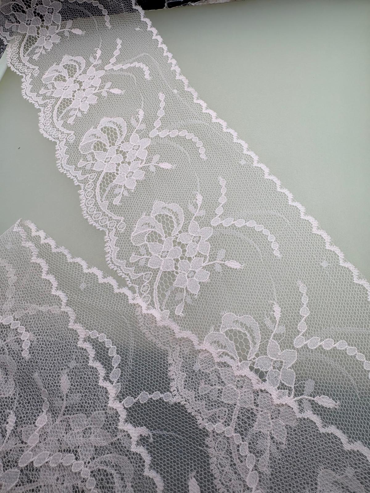 Sheer white embroidered organza with floral and trailing vine design